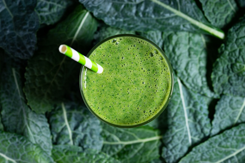 green smoothie in a glass with kale