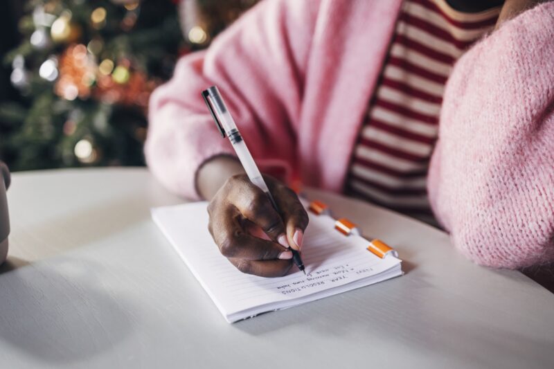 Woman Writing New Year's Resolutions