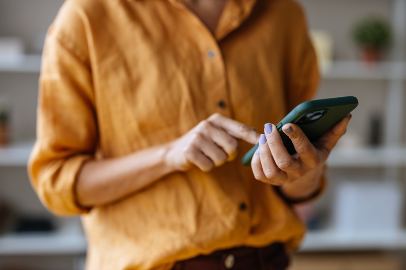 woman online grocery shopping on phone