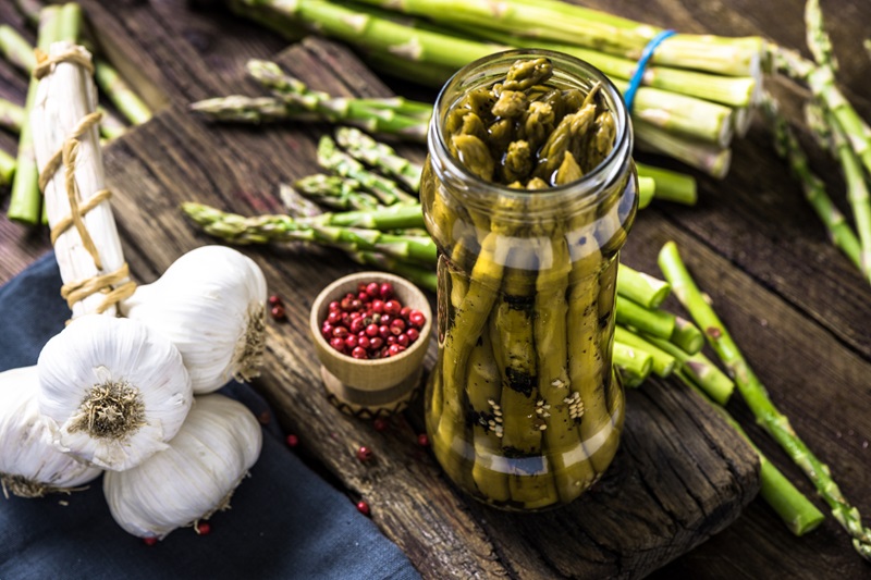pickled asparagus with garlic and peppercorns in a jar