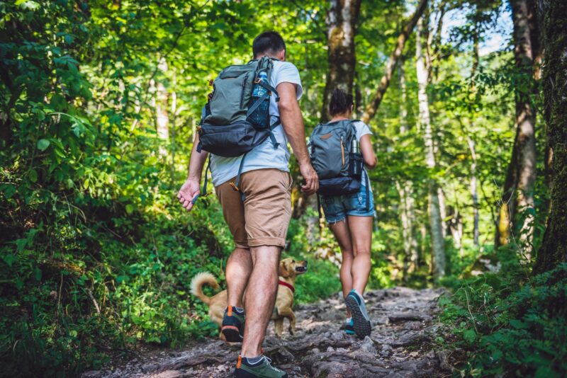 couple hiking and rucking in the woods