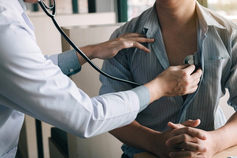 doctor using a stethoscope to listen to the heartbeat 