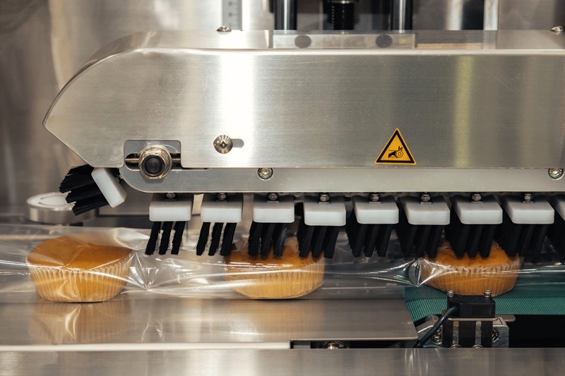 muffins being packaged in a food processing factory
