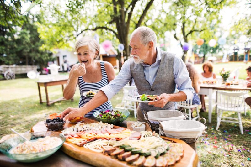 man and woman eating mindfully at a summer event