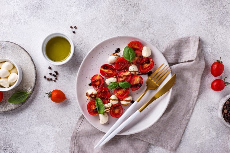 Caprese salad with cherry tomatoes, fresh basil and mozzarella cheese