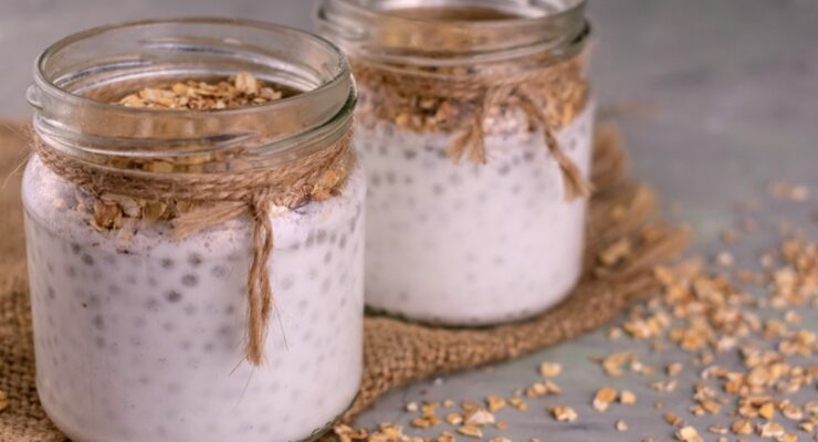 Jars of yogurt with chia seeds and granola.
