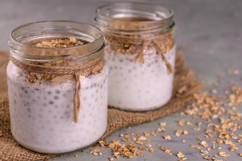 Jars of yogurt with chia seeds and granola.