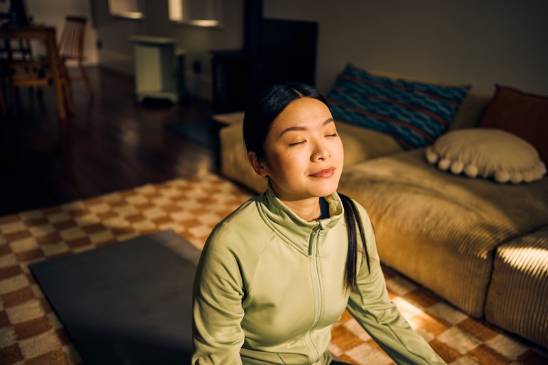 woman meditating in living room