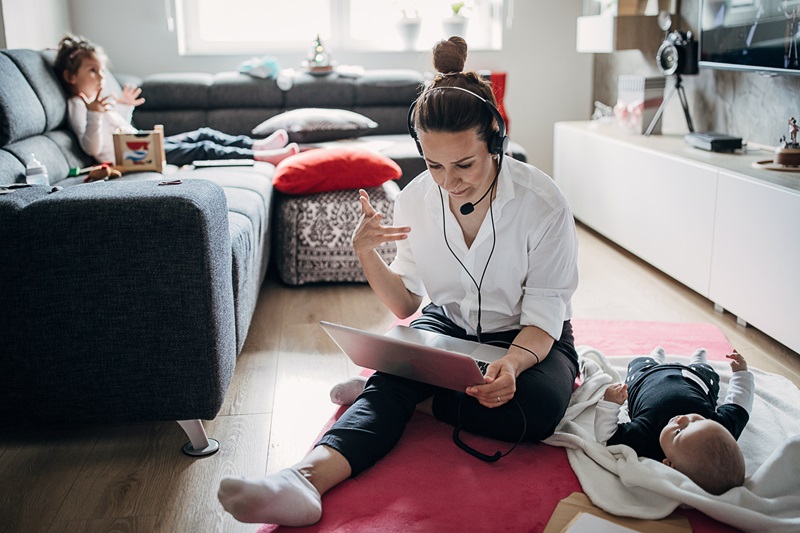 mother working at home and watching kids at the same time