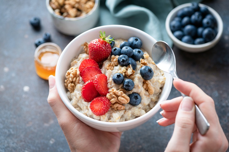 a high fiber bowl of oatmeal with fruit and nuts - fiber may help with balancing hormones for weight loss