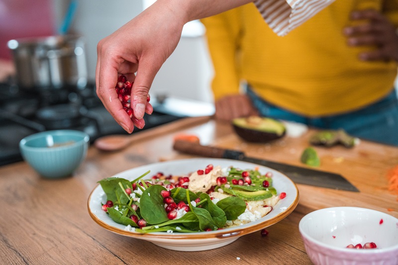 Pomegranate seeds on salad are a healthy fall superfood