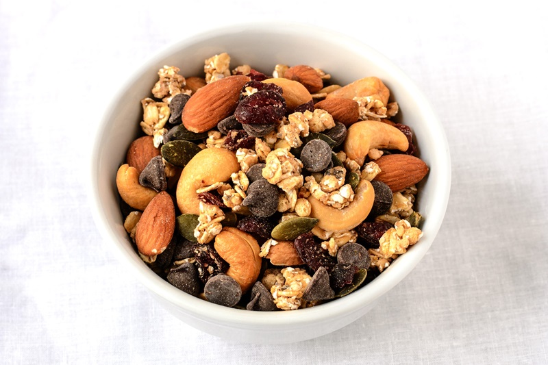 Trail mix of nutrient rich foods like nuts, fortified cereal and dark chocolate that may help with balancing hormones for weight loss