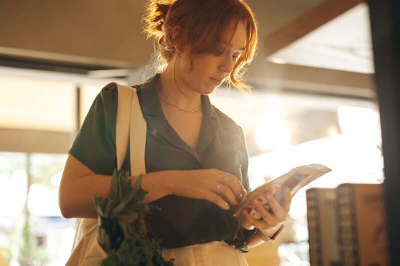 woman reading a food label looking for health claims