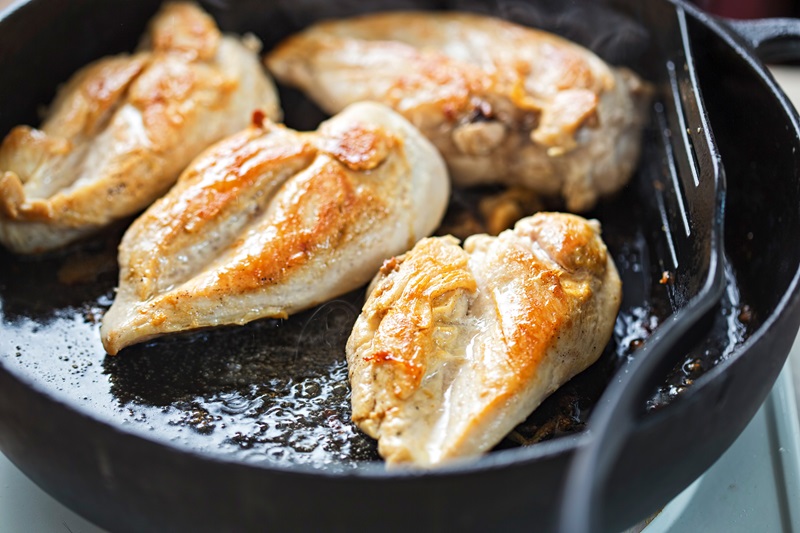 meal prepping chicken breasts for healthy high-protein meals