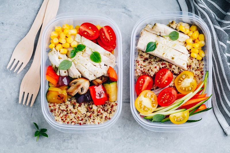 high protein Meal prep lunch box containers with quinoa, grilled and fresh vegetables and chicken