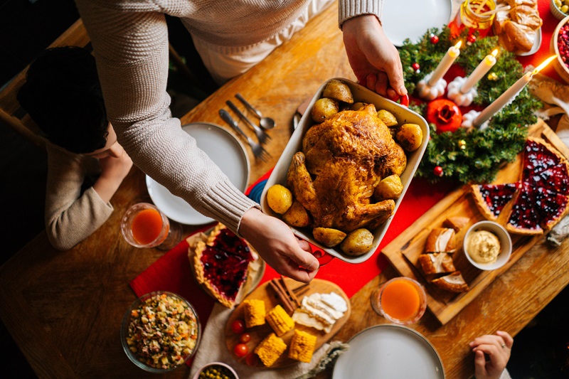 healthy holiday dinner on a table surrounded by family 