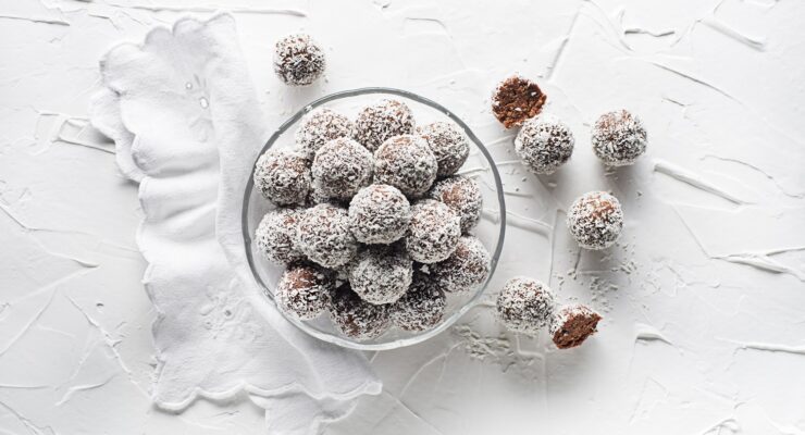 coconut covered gingerbread snowball cookies in a bowl - one of the best holiday gingerbread recipes!