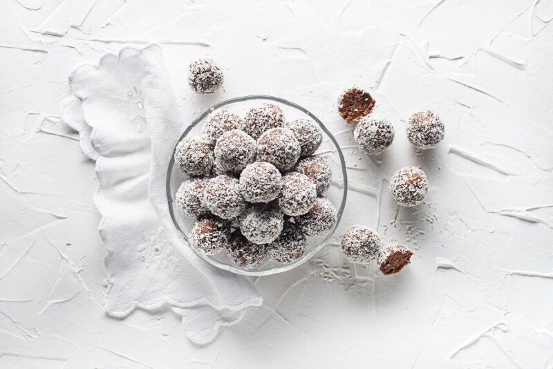 coconut covered gingerbread snowball cookies in a bowl - one of the best holiday gingerbread recipes!