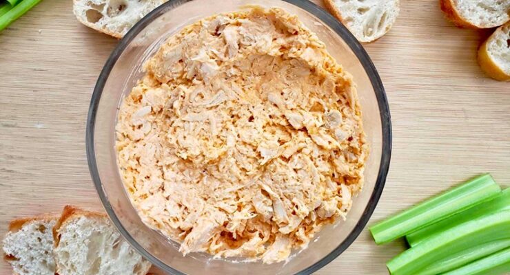 Healthy Buffalo Chicken Dip with slices of bread and celery