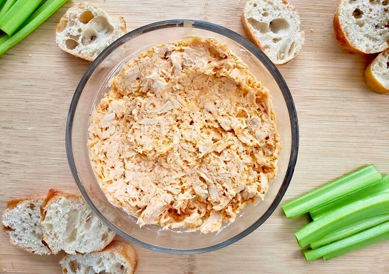 Healthy Buffalo Chicken Dip with slices of bread and celery