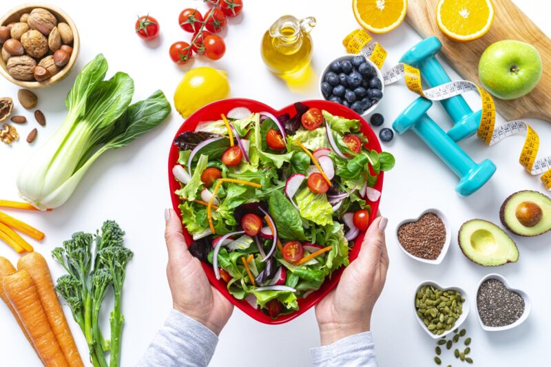 healthy living concept with healthy food and dumbbells