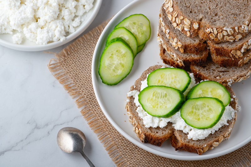 a snack with both fiber and protein, cottage cheese and cucumber slices on whole grain toast