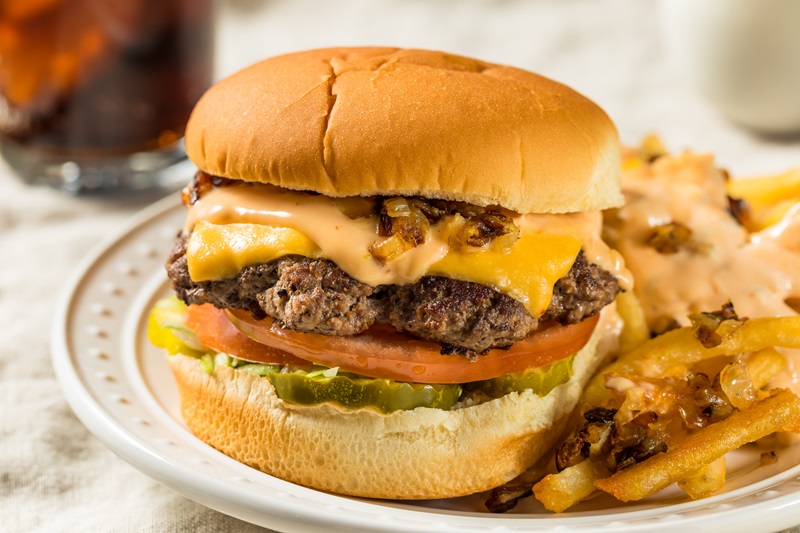 Thin and Crispy Cheeseburgers with Burger Sauce and Grilled Onions
