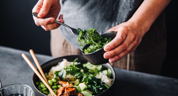 person adding Wakame superfood to their meal