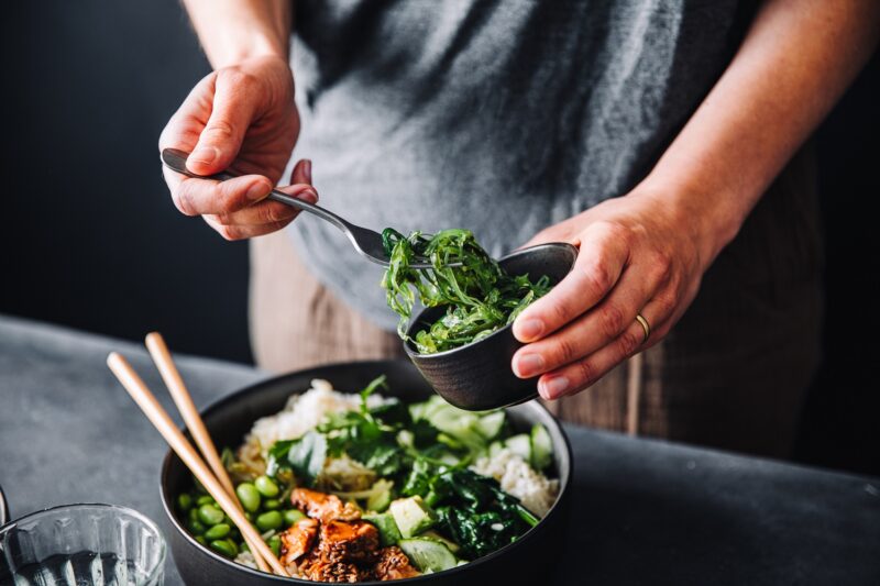 person adding Wakame superfood to their meal