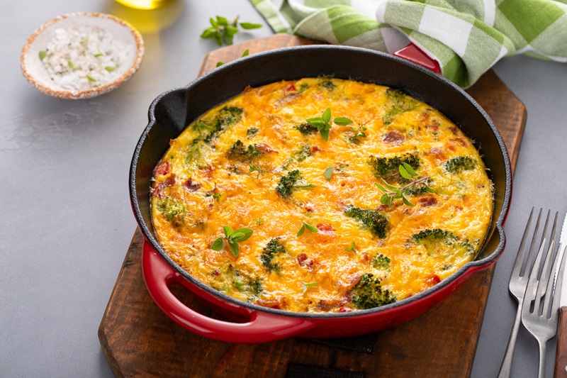 broccoli bacon and eggs in a skillet