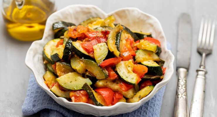 diced and cooked zucchini and tomatoes in a bowl