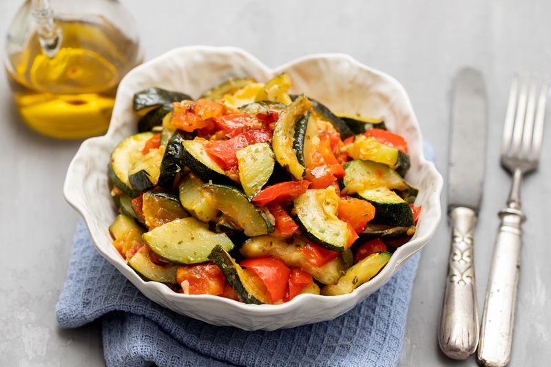 diced and cooked zucchini and tomatoes in a bowl